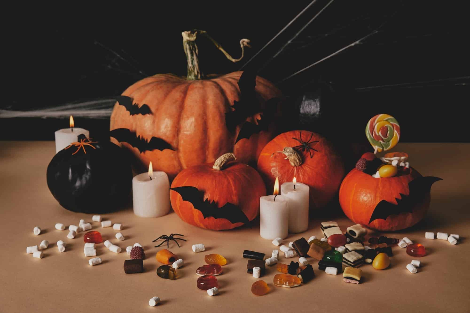 Pumpkins with candles, bats and candy