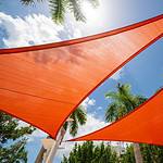 Orange colored sun shade in a park outdoors