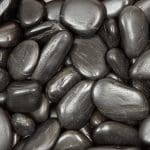Tiny black stones forming a dark background.